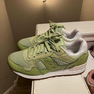 Green and White Saucony Shadow